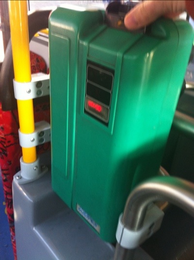 the green ticket machine in a Sydney Bus